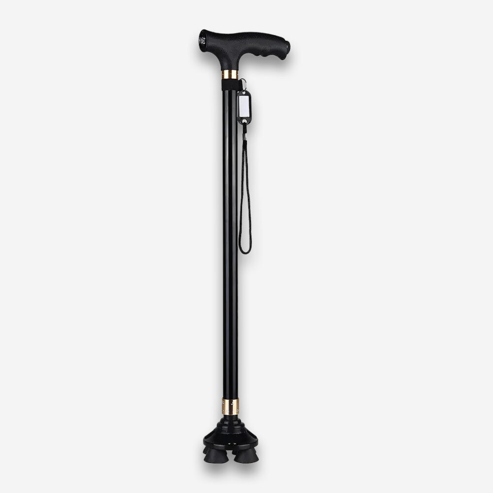 Une canne marche orthopédique antidéparante améliorée, entièrement noire avec un corps en aluminium et 4 pieds antidérapants, vue de profil sur un fond gris très clair uni.