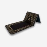 Tapis de prière orthopédique noir avec support dorsal replié, motifs dorés, vue de trois quarts, sur fond neutre.